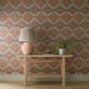 orange botanical wallpaper and wall with side table and vases