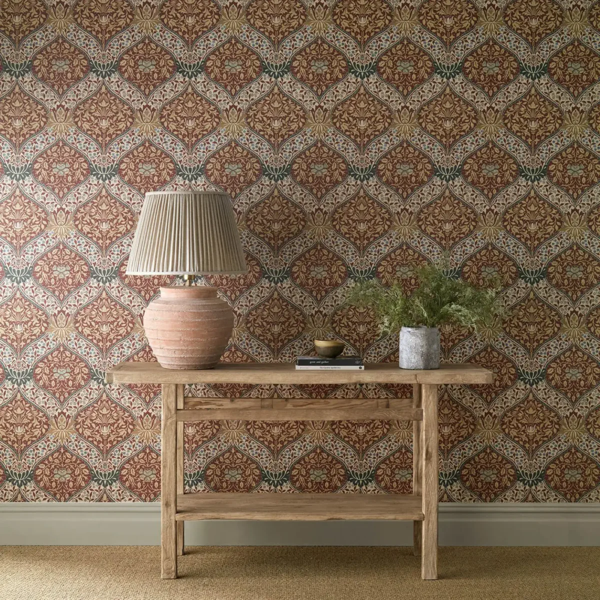 Norbury Wallpaper - Brick / Teal by orange botanical wallpaper and wall with side table and vases