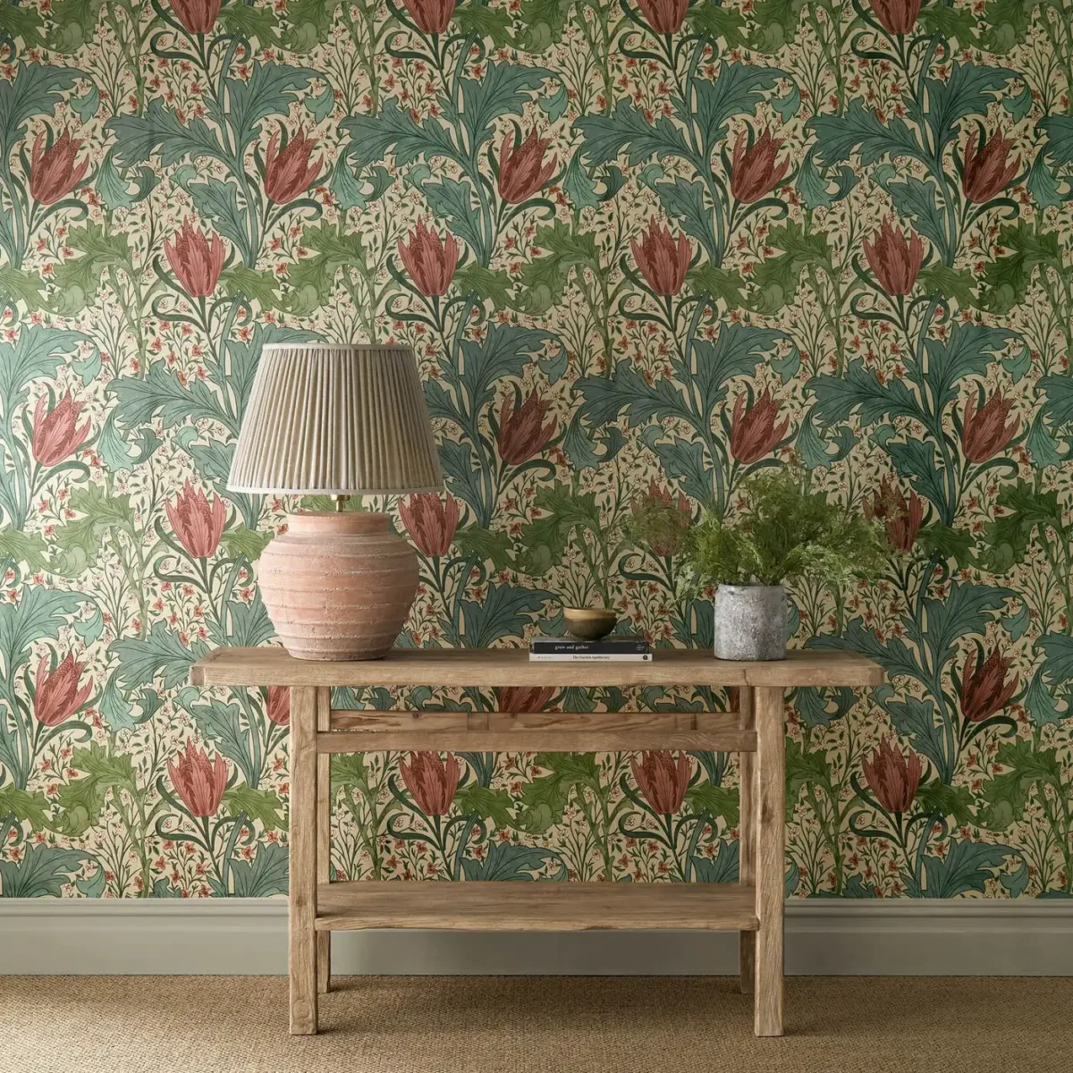 Lent Lily Wallpaper - Plum / Bayleaf by red botanical wallpaper and wall with side table and vases
