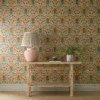 blue botanical wallpaper and wall with side table and vases