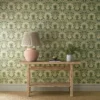 green botanical wallpaper and wall with side table and vases