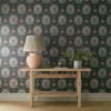 red botanical wallpaper and wall with side table and vases