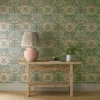 yellow botanical wallpaper and wall with side table and vases