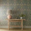 green botanical wallpaper and wall with side table and vases