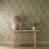 green botanical wallpaper and wall with side table and vases