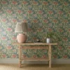 green botanical wallpaper and wall with side table and vases