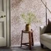 orange botanical wallpaper and wall with side table and door