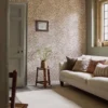 orange botanical wallpaper and wall with sofa and side table
