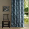 blue botanical curtain with chair and window