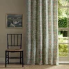 green botanical curtain with chair and window