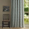 green botanical curtain with chair and window