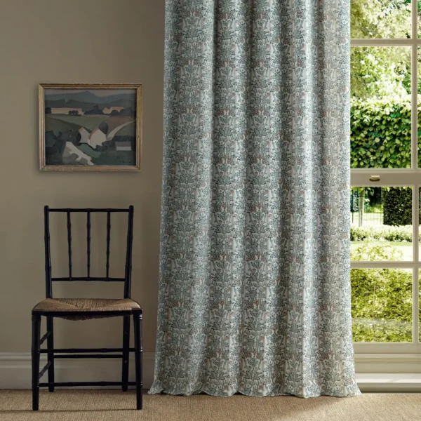 green botanical curtain with chair and window
