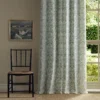 blue botanical curtain with chair and window