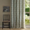 green botanical curtain with chair and window