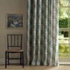 blue botanical curtain with chair and window