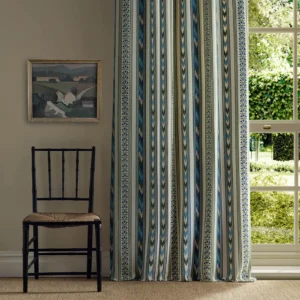 green striped curtain with window and chair
