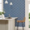 blue geometric wallpaper and wall with chair and dining table