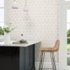 neutral geometric wallpaper and wall with chair and dining table