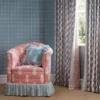 green striped curtain with armchair and cushion