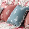pink botanical cushion with cushion and sofa