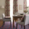 red botanical curtain with cushion and dining table