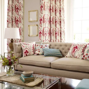 red botanical curtain with sofa and armchair