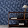 blue contemporary wallpaper and wall with bookshelf and vases