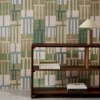 green geometric wallpaper and wall with bookshelf and vases