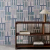 blue geometric wallpaper and wall with bookshelf and vases