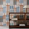 blue geometric wallpaper and wall with bookshelf and vases