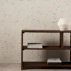 blue spotted wallpaper and wall with bookshelf and vases