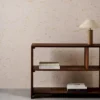 yellow spotted wallpaper and wall with bookshelf and vases