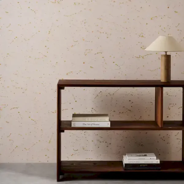 yellow spotted wallpaper and wall with bookshelf and vases