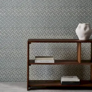 blue spotted wallpaper and wall with bookshelf and vases