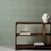 green spotted wallpaper and wall with bookshelf and vases