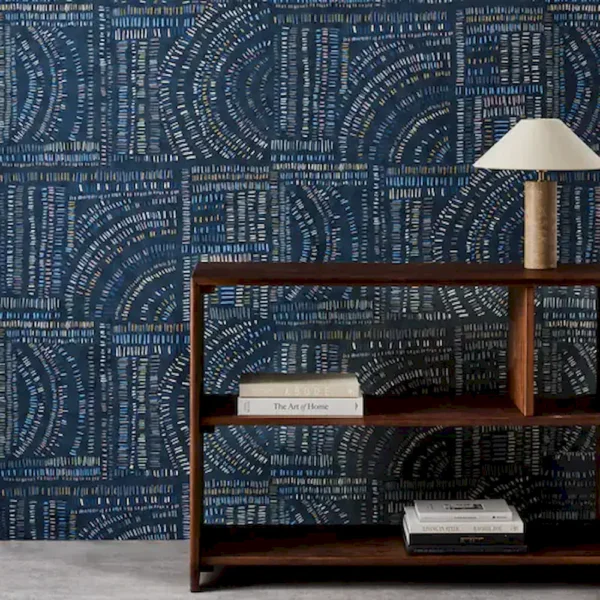 blue geometric wallpaper and wall with bookshelf and vases