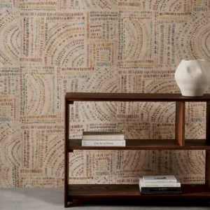 orange geometric wallpaper and wall with bookshelf and vases