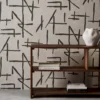 brown geometric wallpaper and wall with bookshelf and vases