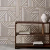 neutral geometric wallpaper and wall with bookshelf and vases