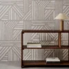 black-grey geometric wallpaper and wall with bookshelf and vases