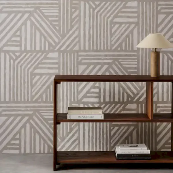 black-grey geometric wallpaper and wall with bookshelf and vases