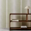 green striped wallpaper and wall with bookshelf and vases