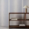 blue striped wallpaper and wall with bookshelf and vases