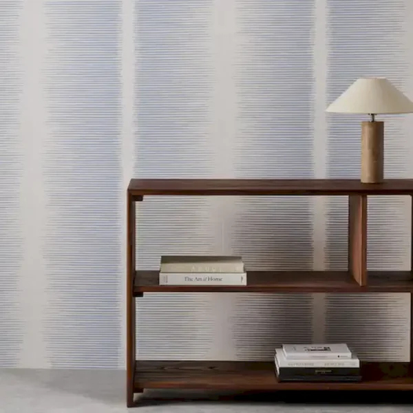 blue striped wallpaper and wall with bookshelf and vases