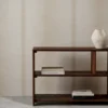 neutral striped wallpaper and wall with bookshelf and vases