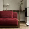 red plain sofa with side table and vases