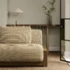 brown plain sofa with side table and vases