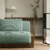 black-grey plain sofa with side table and vases