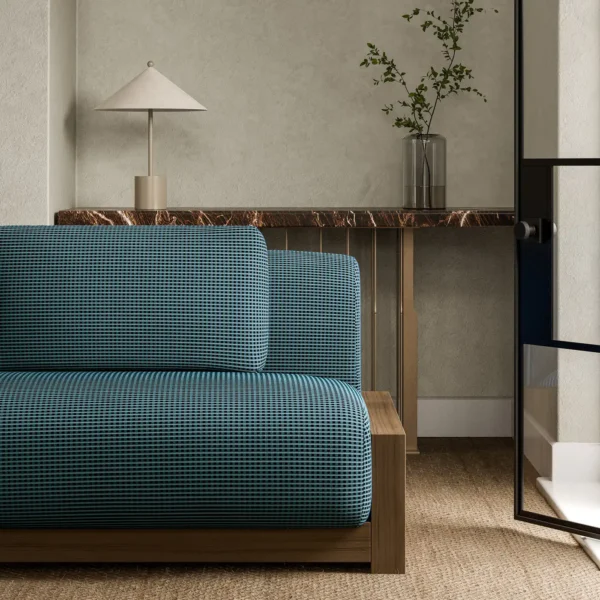 blue plain sofa with side table and vases