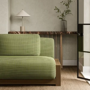 green plain sofa with side table and vases